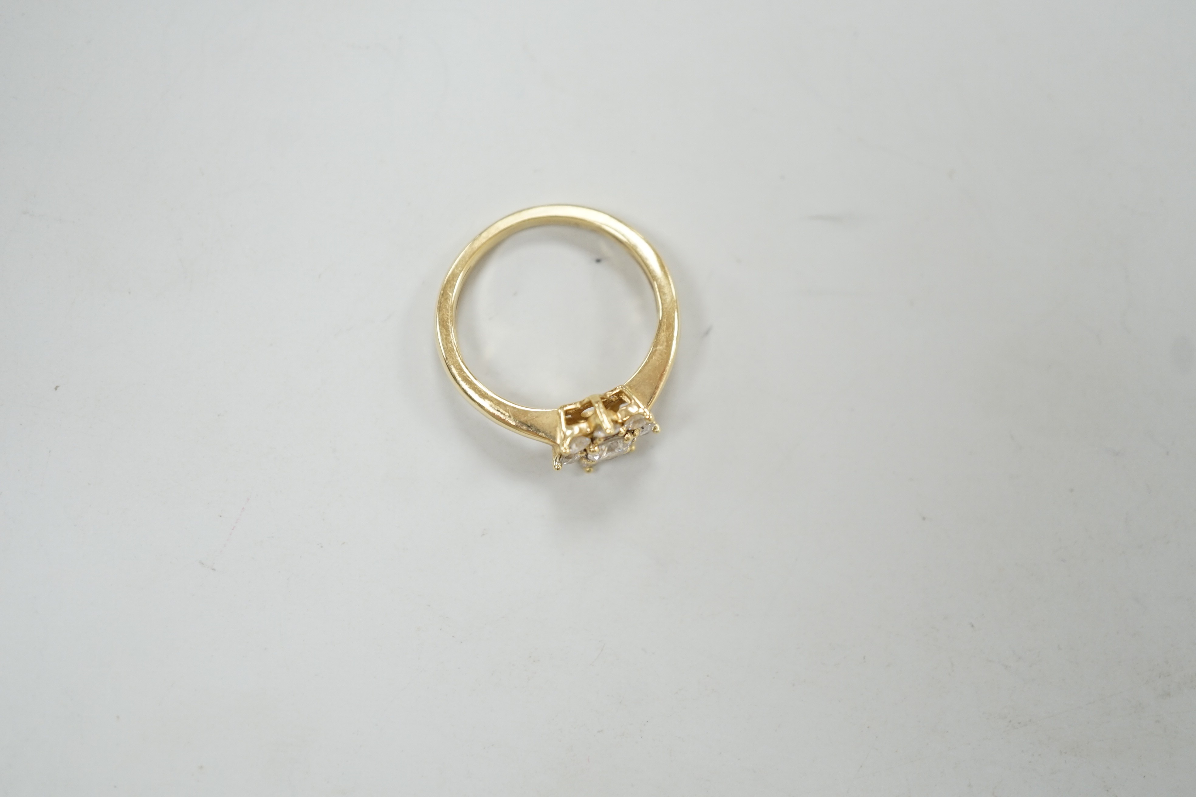 A modern yellow metal and diamond set flower head cluster ring, size L, gross weight 2.9 grams.